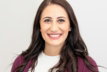 woman in red cardigan smiling