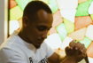 man in white crew neck t-shirt and gray pants holding white textile
